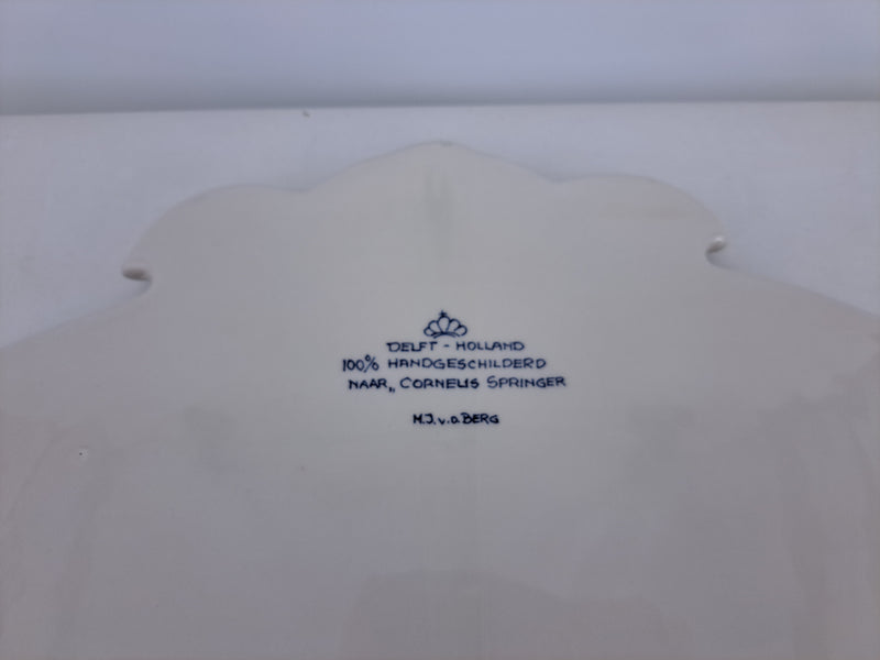 Backside of a delftware plaque with delftpainters signature and description.