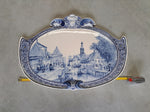 large oval delftware plaque with an old Dutch city view.