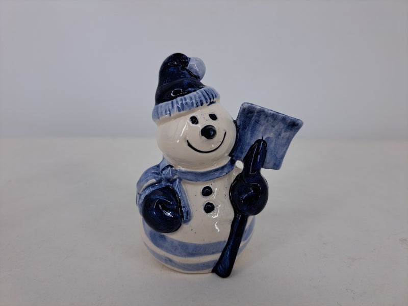 Delft handpainted snowman holding a shovel.