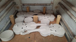 Opened ceramic kiln showing ceramic large bisquefired violins.