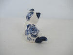 Back view of a sitting delftblue kittens with floral delft pattern on its back.