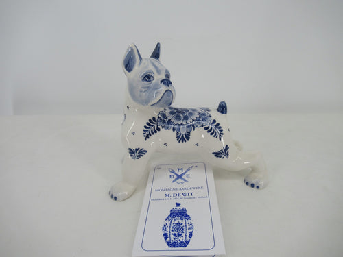 Front view of a delftblue ceramic dog handpainted in a fine floral design.