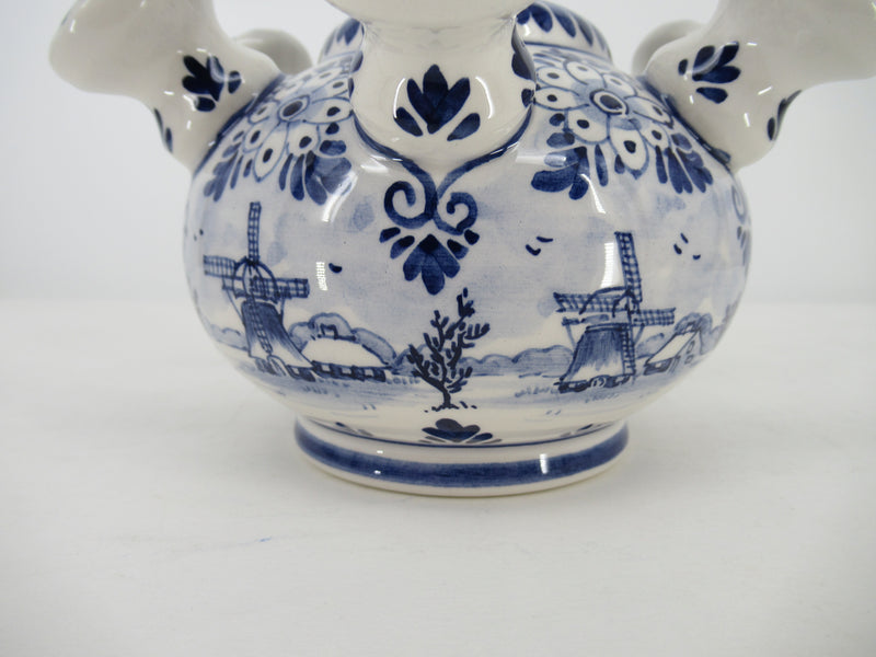 a detailed picture of a delftblue vase depicting several windmills.