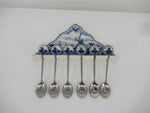 delftblue spoonrest with six spoons.