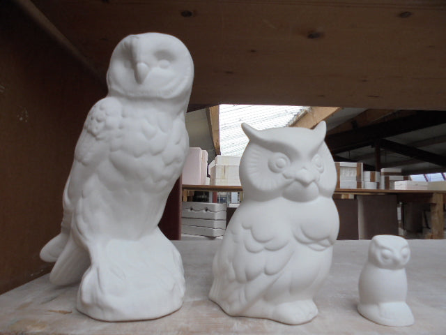 three animal figurines of ceramic bisqueware.