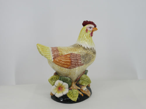 Large polychrome delft ceramic hen seen from behind.