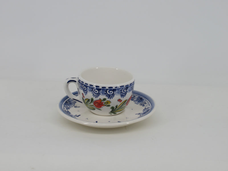 delftblue cup and saucer with red tulip design.