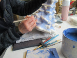 ceramic Delft Christmas tree while being painted.