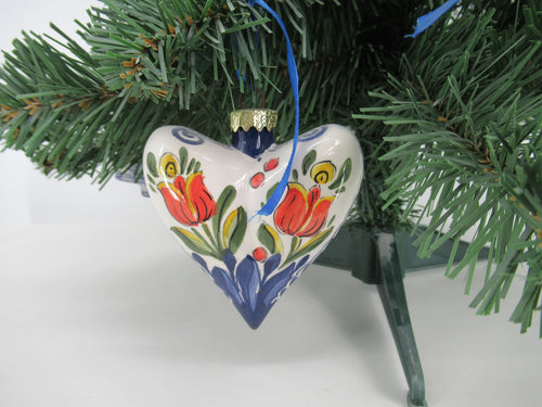 heartshaped ceramic Christmas bauble hanging in a tree