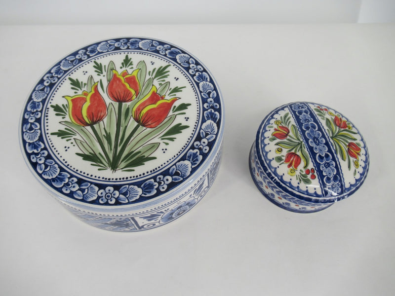 Large and smaller ceramic cookiesboxes with red tulips.