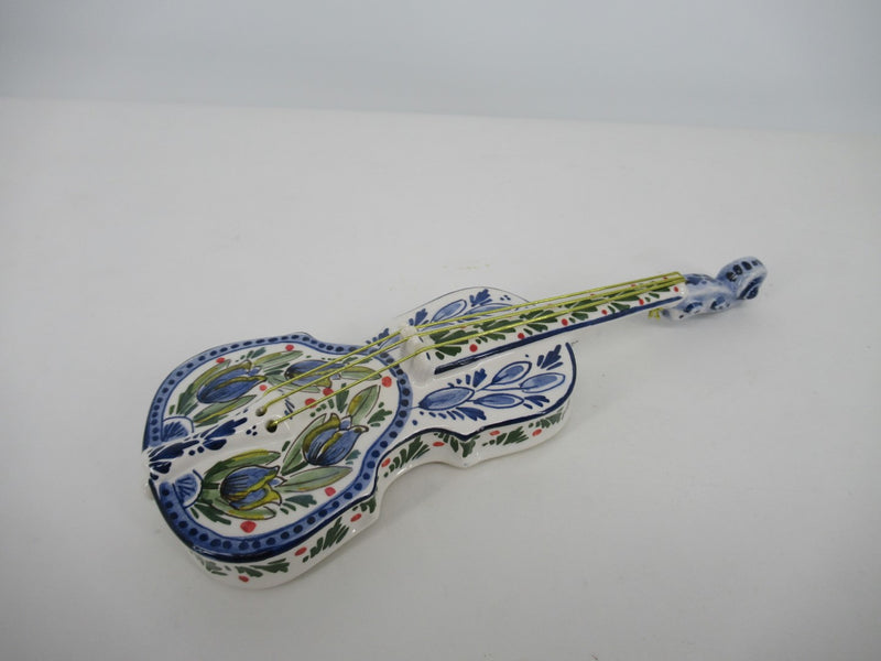 ceramic delftblue violin with blue tulip design.
