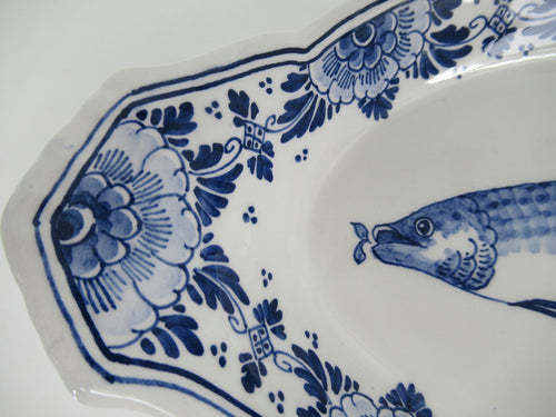 close up detail of a delftblue herring dish