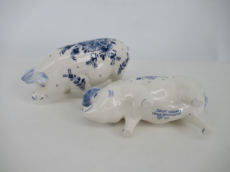 two delftblue pigs one showing brand mark