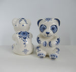 Delftblue ceramic teddybears, showing front and backside of floral design.