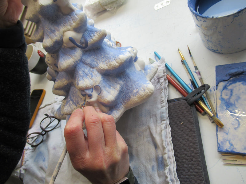 Delftblue Christmas tree being painted by artist.