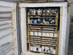 view of a fully loaded ceramic kiln that has been opened after firing.