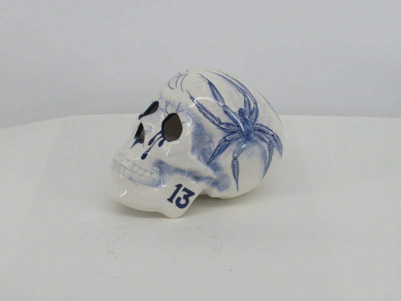 Delftblue ceramic skull painted with a tattoostyle spider