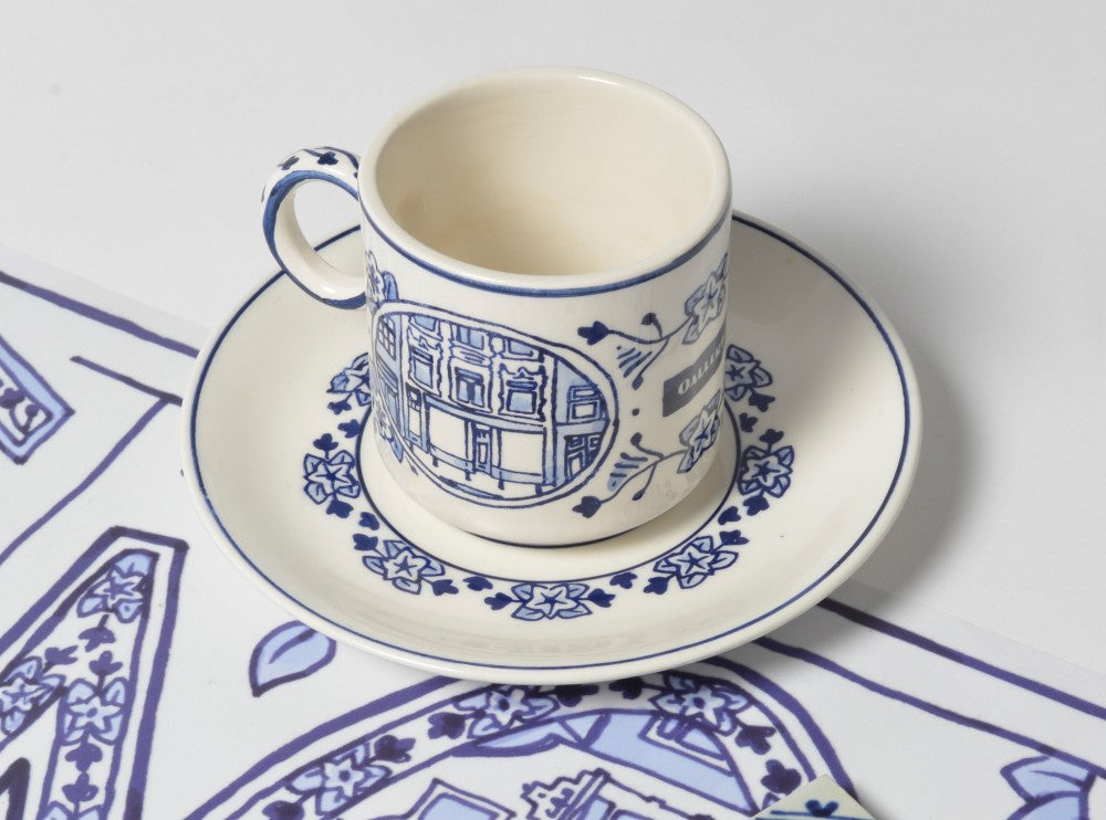 a delftblue cup and saucer in a personalized delft design on commision for an Amsterdam fashion retailer.
