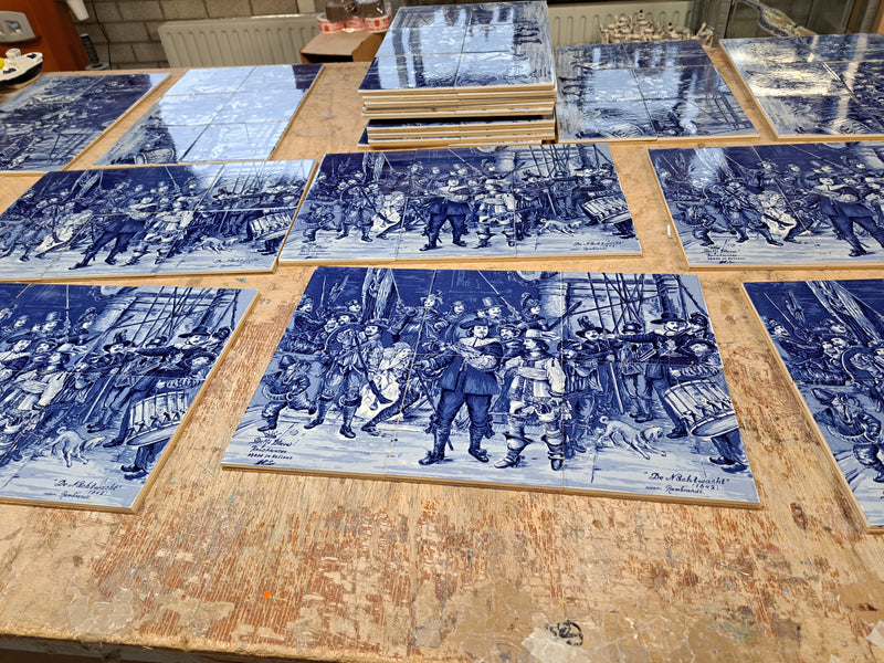 Pic of a packing table in our warehouse full of delftblue Rembrandt tile panels before shipping.