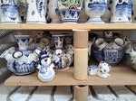Glimpse of a just opend ceramic kiln, showing delftblue tulip vases and delftblue cat.