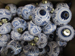 Box full of ``de Wit`` delftblue christmas ornaments all in the same floral design.