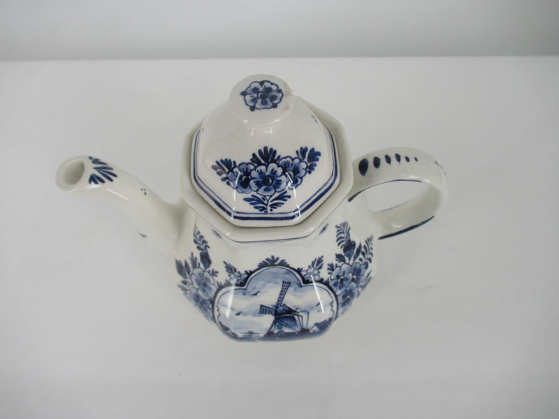  view of a delftblue teapot with windmill design from above.