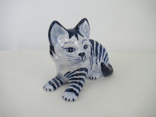 Front view a a delftblue sitting striped cat.