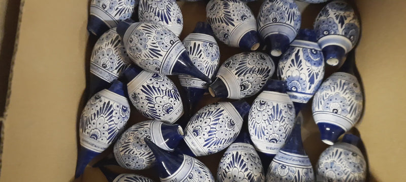 collection of delftblue Christmas ornaments grouped by design before shipping.