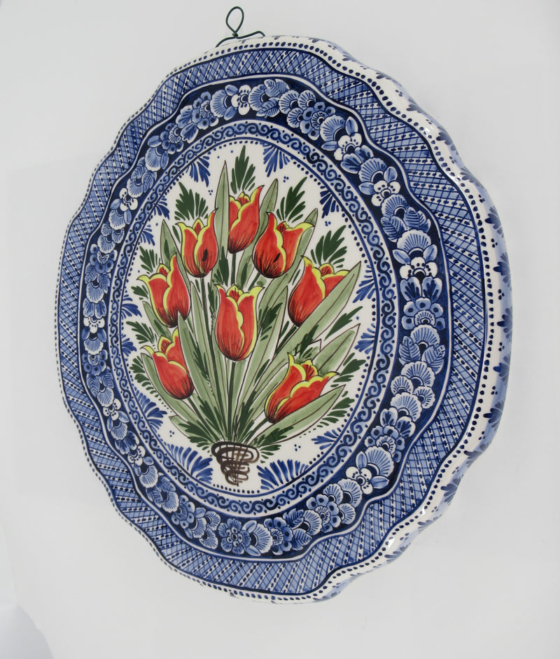 ceramic mural with a handpainted red tulip bouquet in a delftblue design