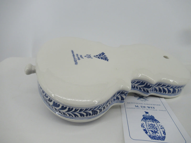 rear view with painters signature of a delftblue ceramic violin