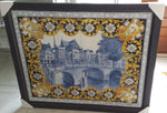 Framed Delftblue tilepanel depicting Dutch canal view with multicolor floral border