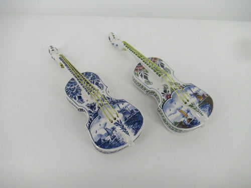 delftblue and polydelft set of small violins.