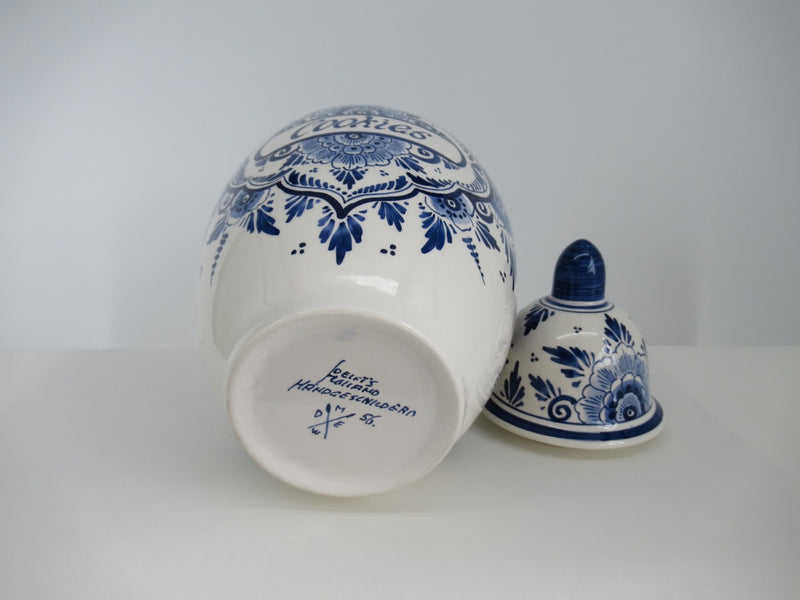 round delftblue cookie jar with marking on bottom visible.
