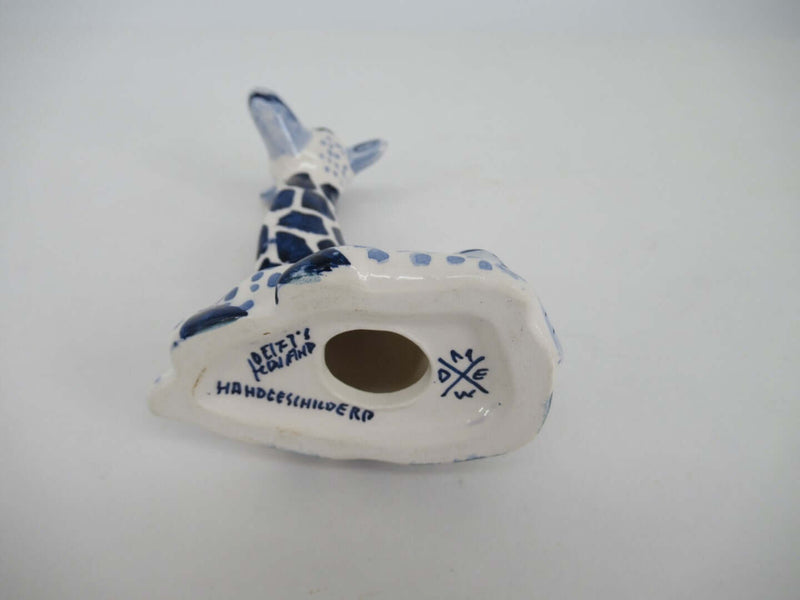 bottomside of a delft blue ceramic giraffe with pottery brand