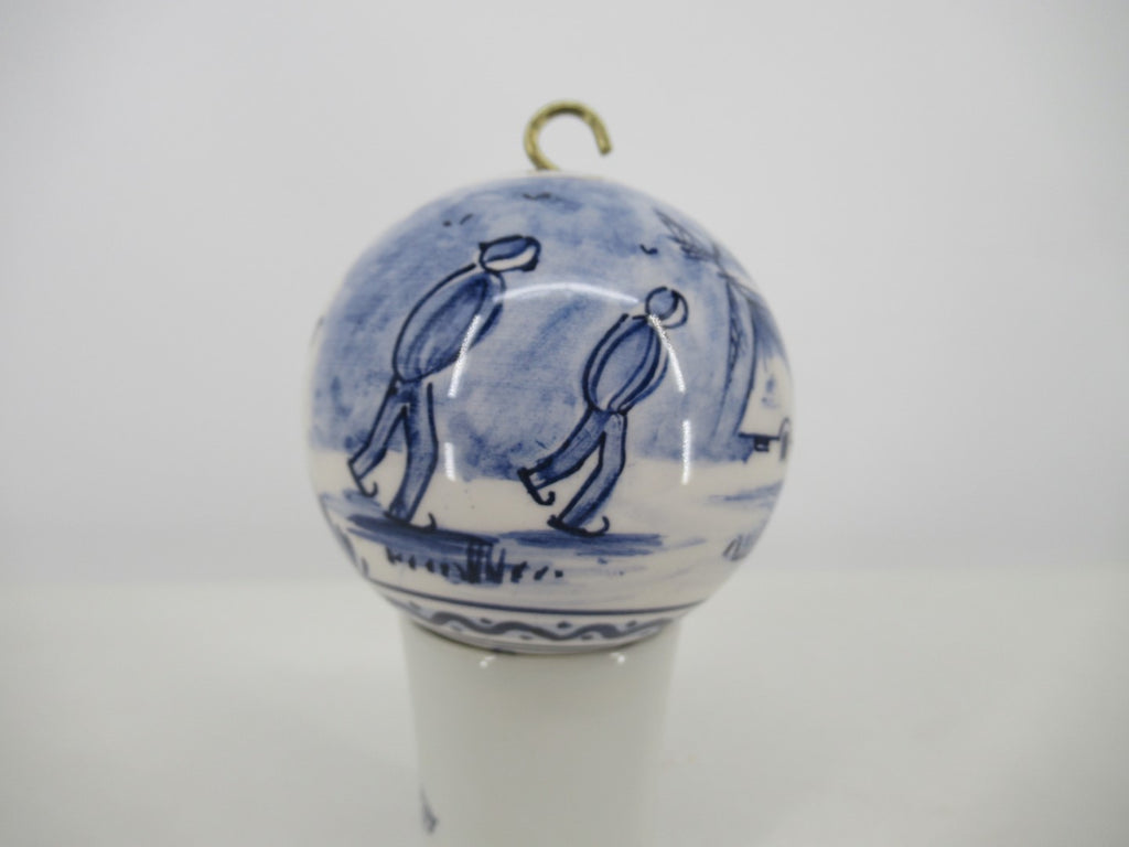 Delft Christmas ornament with ice skaters in a Dutch landscape