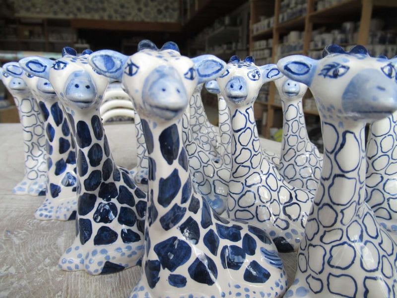 group of painted but yet unglazed delftblue giraffes