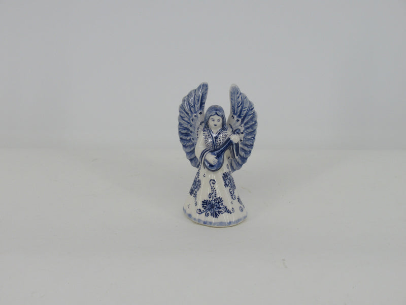 Delft ceramic christmas angel plating a guitar